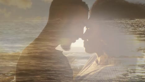 Animation-of-romantic-african-american-couple-at-beach-touching-heads,-over-sea