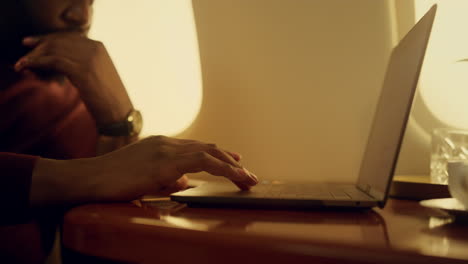 Stressed-manager-browsing-laptop-closeup.-Focused-african-american-touching-pad