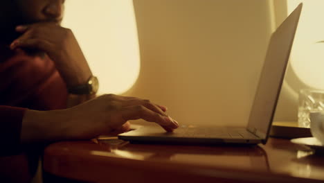 stressed manager browsing laptop closeup. focused african american touching pad