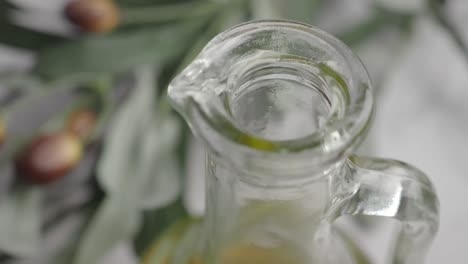 pouring olive oil from glass bottle