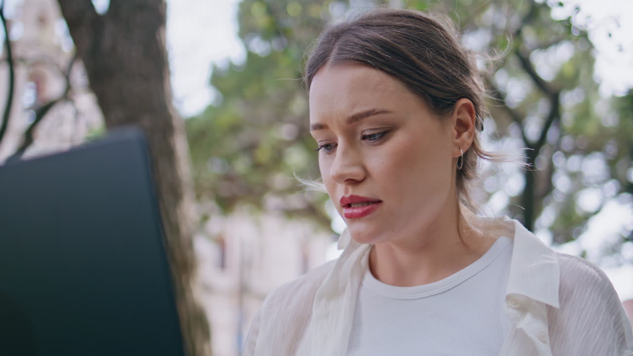 Focused freelancer working nature looking at laptop closeup. Portrait woman