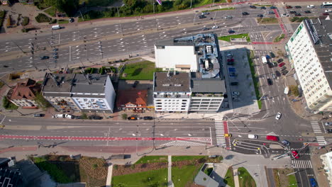 aerial view of a bustling city intersection with diverse buildings and traffic