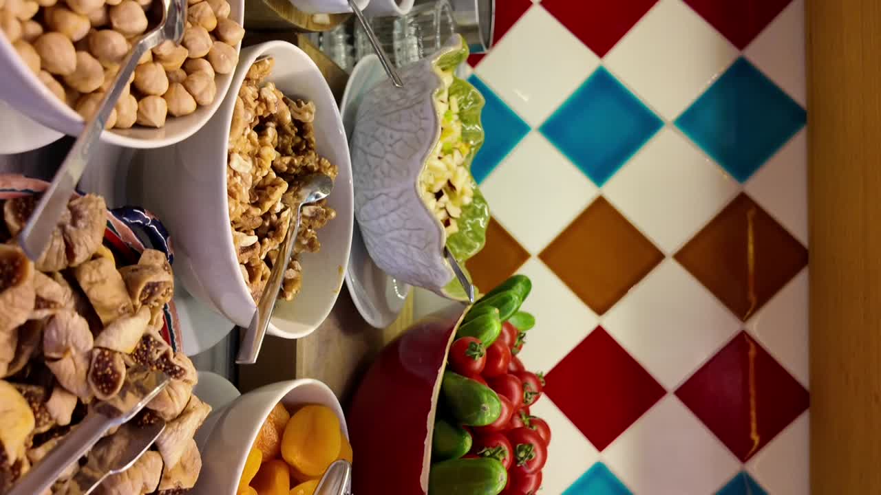 A vibrant buffet spread featuring an assortment of dried fruits, nuts, and fresh vegetables