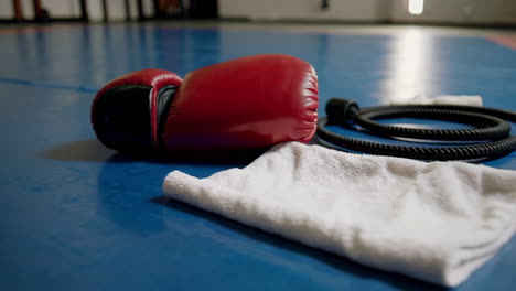boxing gloves and towel on gym floor