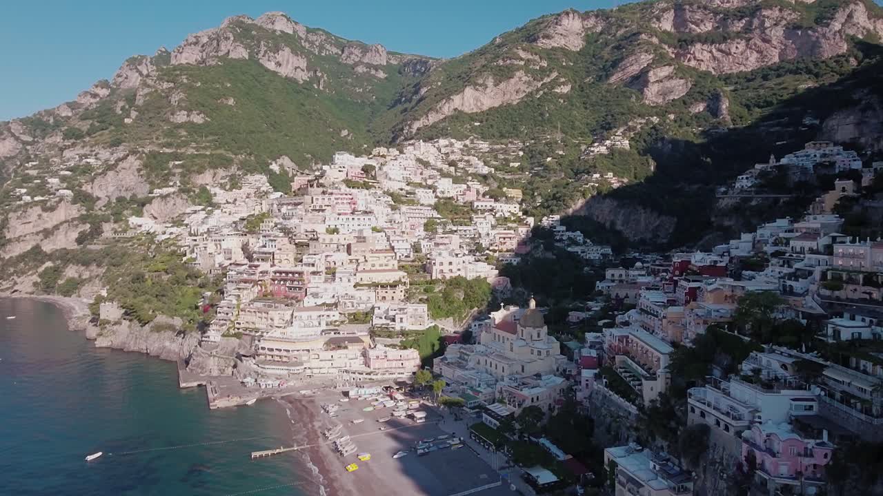 Aerial Drone shot Tilt Down looking at Buildings and Beach in Positano, Italy