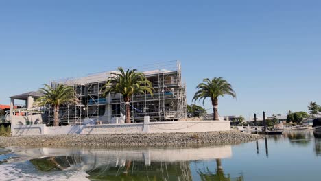 house under construction near a canal