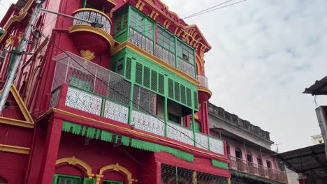 tilt up view of old red calcutta style architecture building in kolkata, india during daytime. vintage architecture.