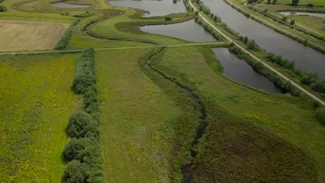 Aerial-drone-view-of-the-beautiful-watery-landscape-and-canal-in-the-Netherlands,-Europe