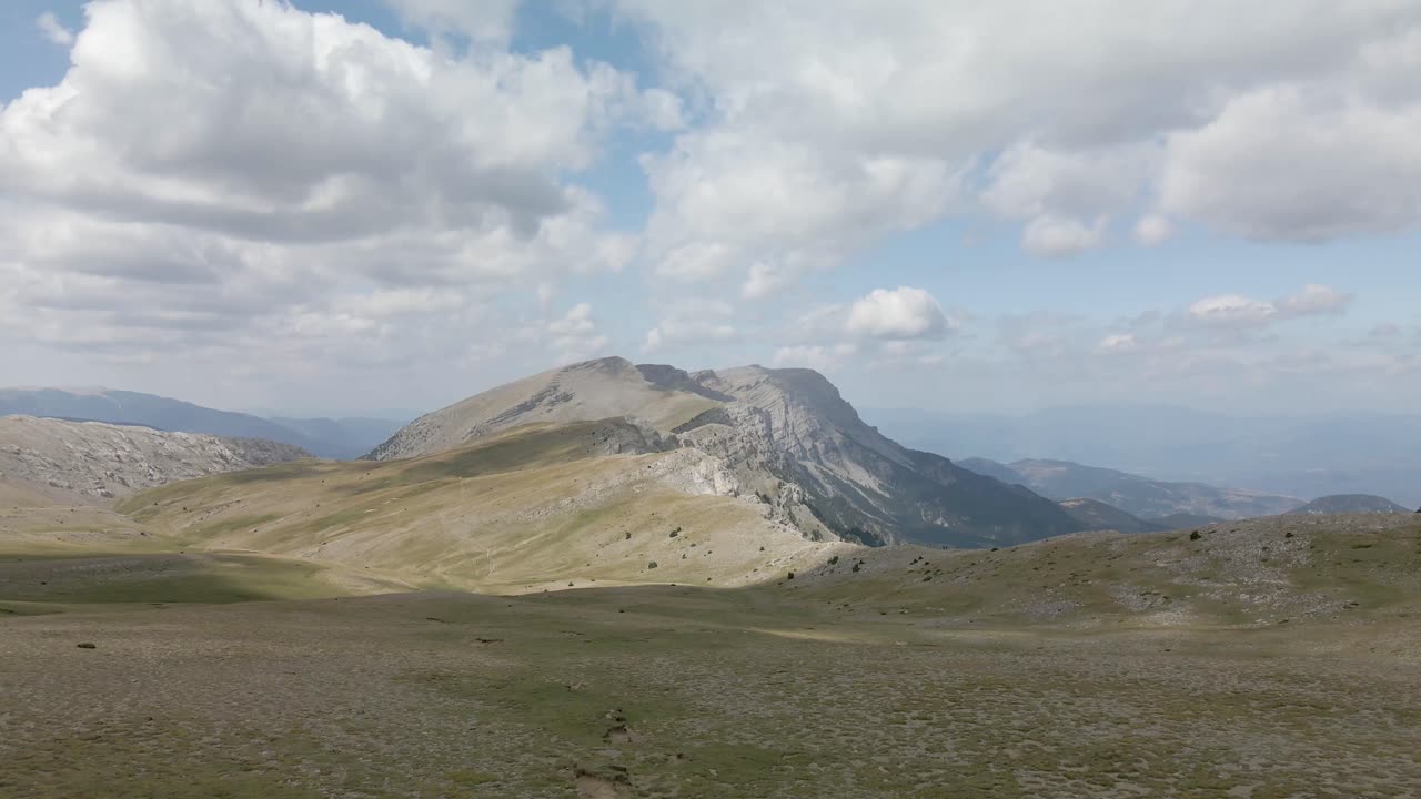 Aerial view of the top of the mountains with clouds making amazing and beautiful silhouettes 4k