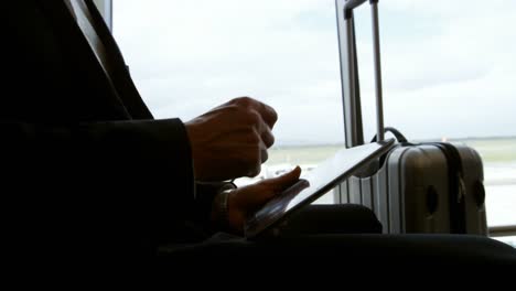 Businessman-using-digital-tablet-at-airport