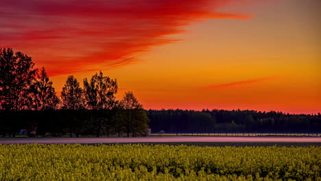 fiery red sky over flowing river at sunset