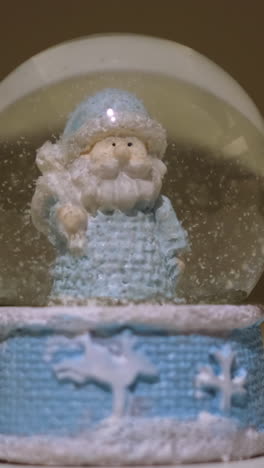 close-up of a blue santa snow globe