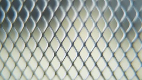 a hyper macro shot of a metal grid, steel pattern, iron industrial texture, aluminum material, super slow motion, full hd 120 fps, tilt up smooth movement, blurry dof