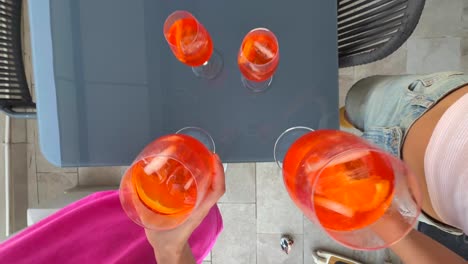 friends enjoying aperol spritz on a patio