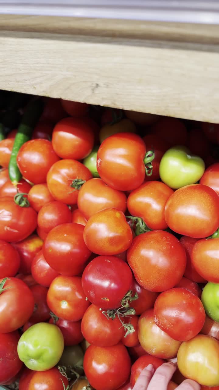Picking Tomatoes from a Grocery Display