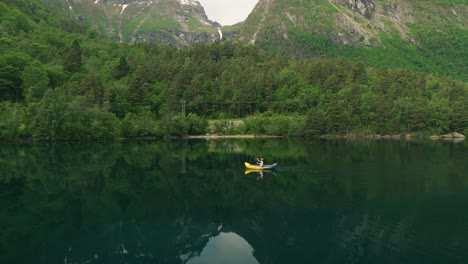 lonely kayak enjoys beauty of norway lake, aerial view
