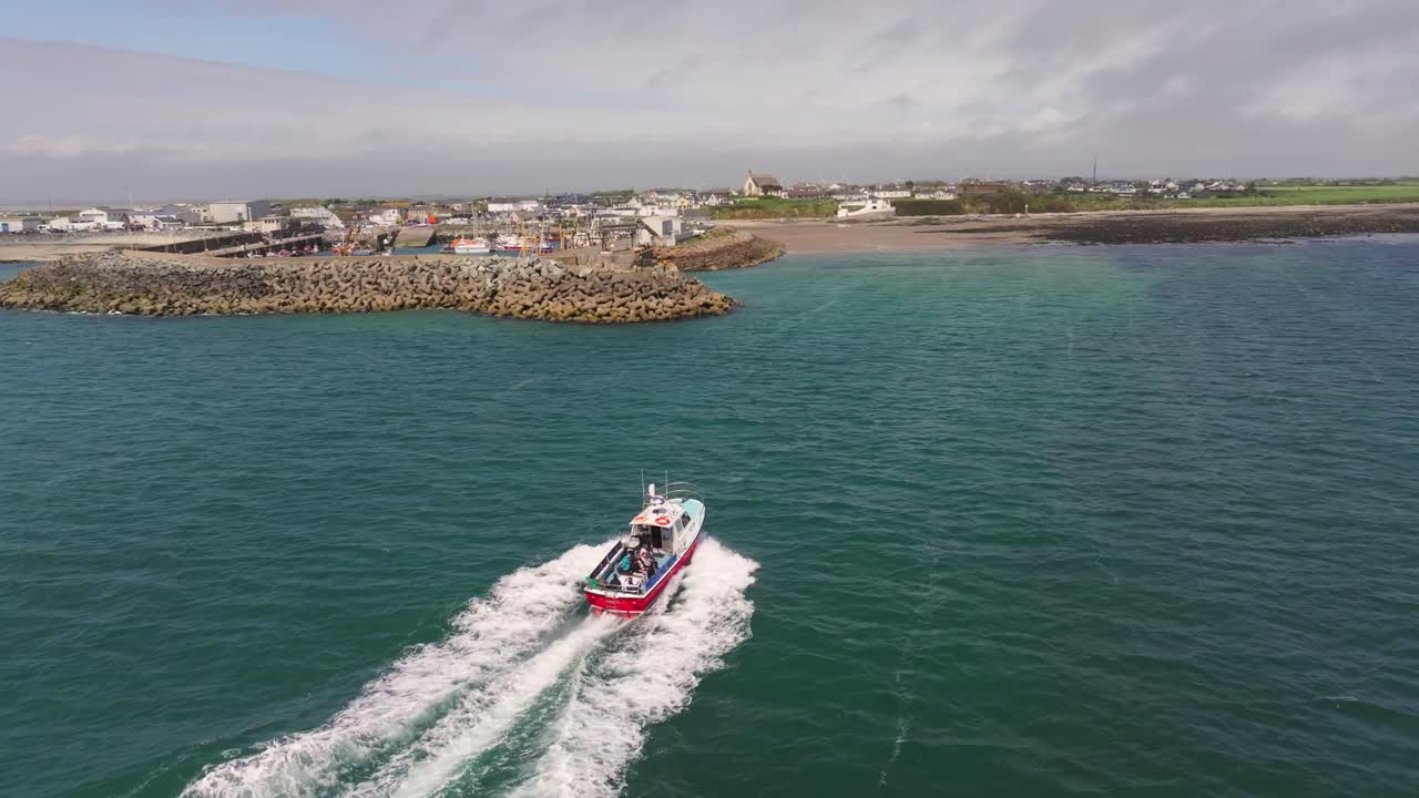 4K cinematic drone footage capturing Kilmore Quay, on a bright day, showcasing the picturesque harbour, and colourful fishing boats Co.Wexford - Ireland_010