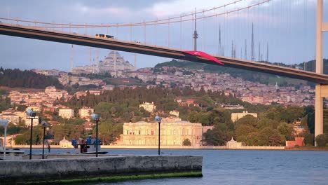 video clip of the bosphorus bridge, shamilja mosque and the bosphorus with the presence of traffic on the bridge and the passage of a fishing boat