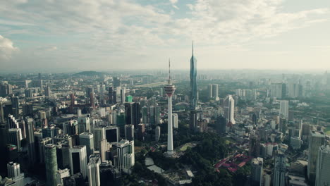 kuala lumpur telecommunication tower with mega tall famous skyscraper merdeka 118 on the right, southeast asia, panoramic drone view