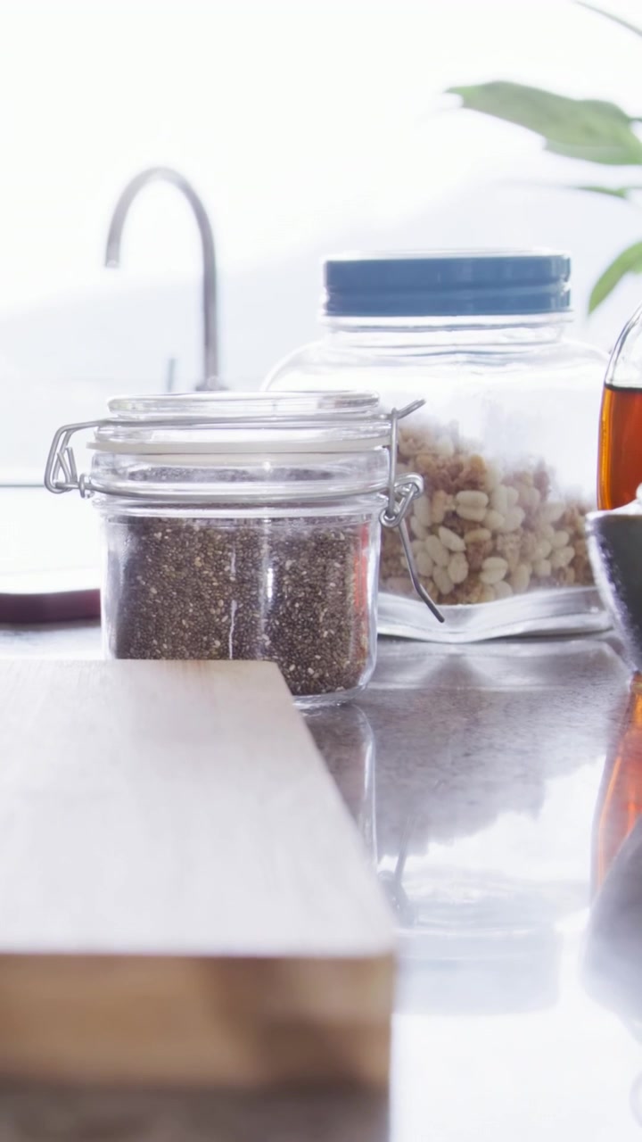 Vertical video: Camera nudging up and right at sink after nudge, revealing spice jar with clamp lid