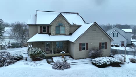 Cozy-two-story-colonial-home-during-winter-snow