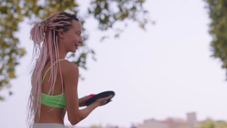 woman playing paddle game outside in the park