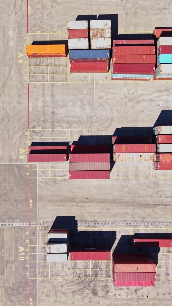 Cargo containers stacked at a shipping yard in the daytime