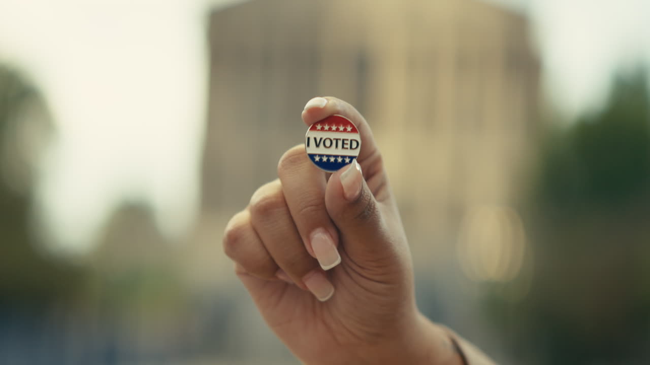 Hand holding I voted button