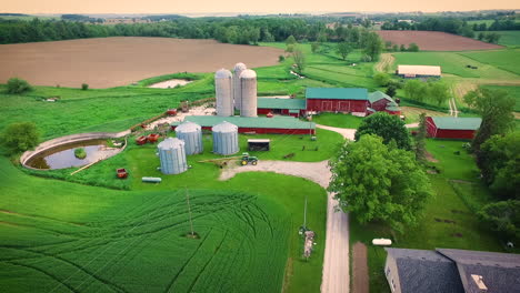 beautiful farm with a large red barn and grain silo