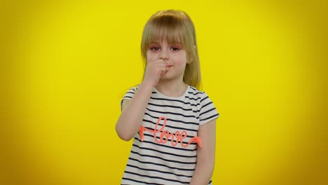 Portrait-of-child-girl-presses-index-finger-to-lips-makes-silence-gesture-sign-do-not-tells-secret