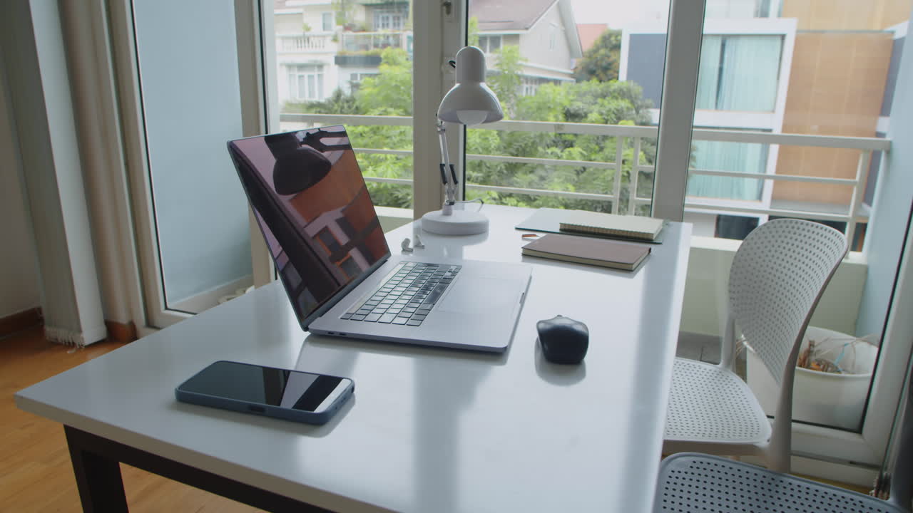 Desk of Office Employee with Wireless Laptop