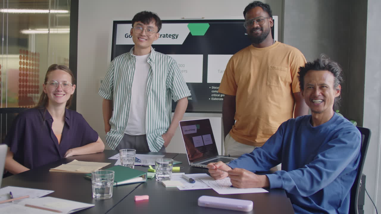 Multi-Ethnic Business Team Posing for Camera in Meeting Room