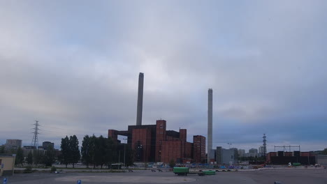 overcast timelapse: activity around grey day power plant in helsinki