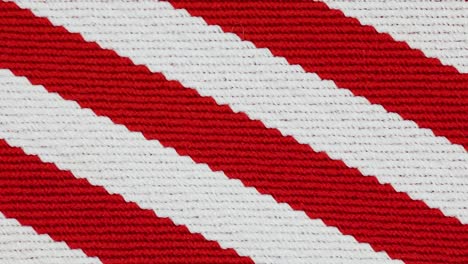 textured knitted fabric with red and white horizontal patterns