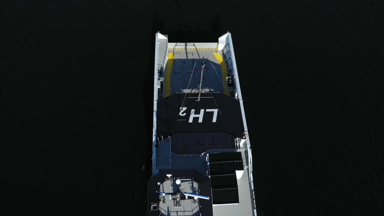 Modern low-carbon vessel Hydra top-down view at sea - Contrasty clip with ship entering into frame against dark sea background - Liquid hydrogen chemical symbol on top - No people or logo - Norway