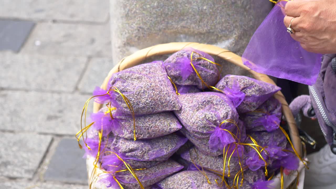 Woman selling dried lavender sachets at an outdoor market