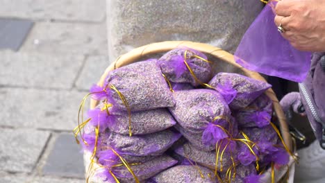 woman selling dried lavender sachets at an outdoor market