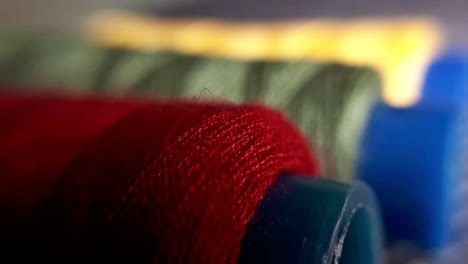 spools of yellow, green and red yarn