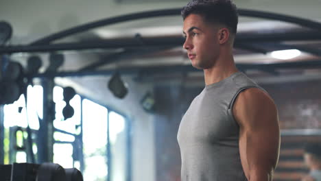 a fit young man working out with dumbbells