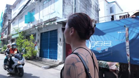 woman walking down a thai back street