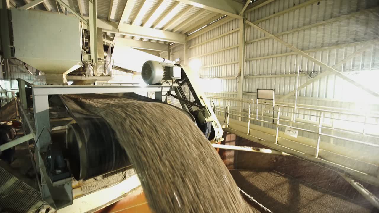 Water Spraying On Cement Clinker From Conveyor Belt In Cement Factory. tilt down