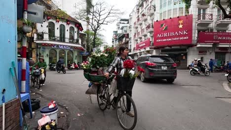 a flower vendor navigates busy hanoi streets