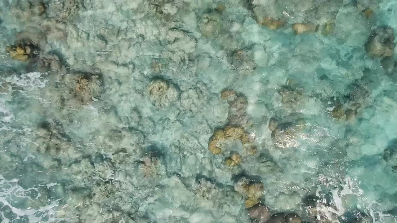 Drone footage of crystal clear blue water and waves on the shore of beach in Cebu Philippines-3