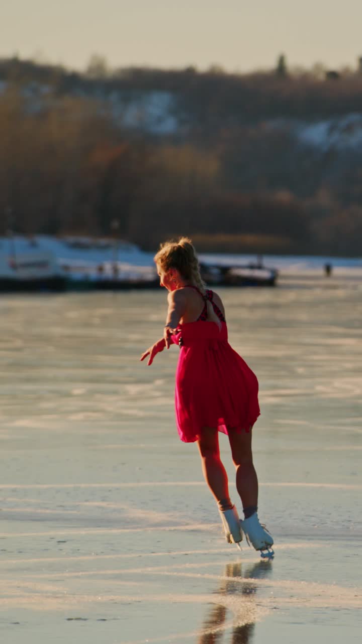 A graceful figure skater in a vibrant red dress gliding effortlessly across a shimmering ice surface, embodying the elegance and artistry of winter sports while capturing the beauty of motion during sunset