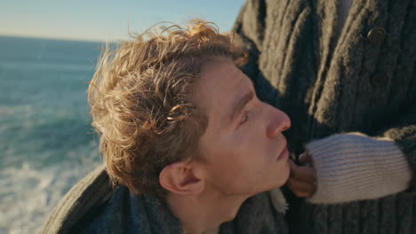woman hands stroking boyfriend head on marine nature closeup. happy couple date