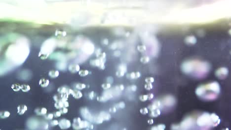 Extreme-Closeup-and-extreme-slo-motion-shot-of-pink-bath-bomb-approaching-water's-surface