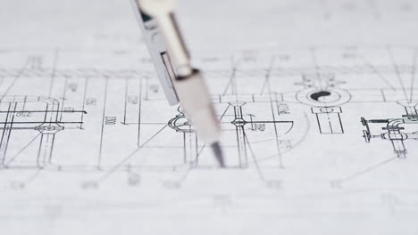 close-up of engineering blueprints and drafting tools