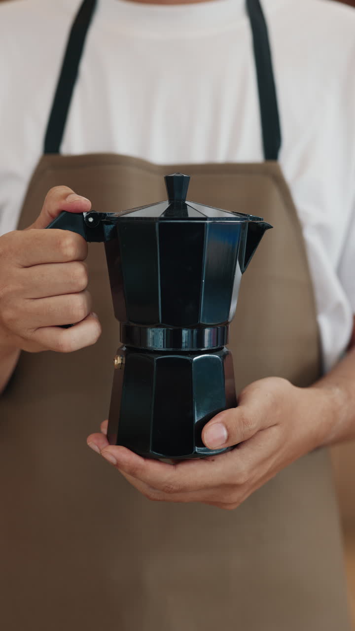 Person holding a Moka pot