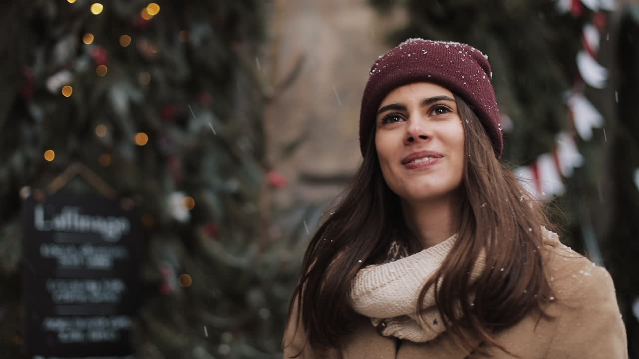 Woman in winter clothing with Christmas decorations