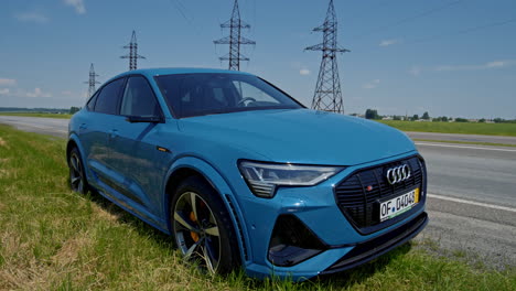 audi e-tron stopped on road. audi e-tron sport 2021 parked on road